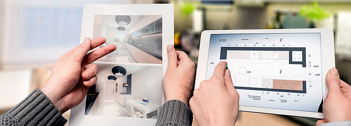 Interior architects who compare the image of kitchen on the tablet and paper. 